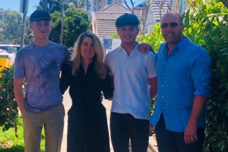 William smiling with his family